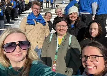 students and instructors take a selfie outdoors 